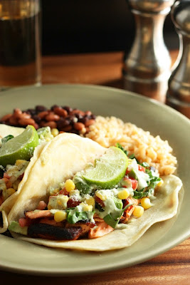 Blackened Salmon Tacos with lime wedges