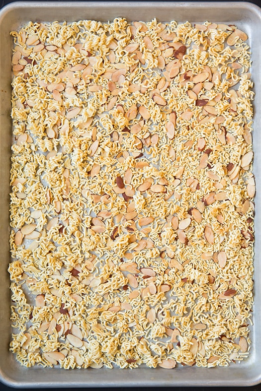 ramen noodles and slivered almonds on baking tray