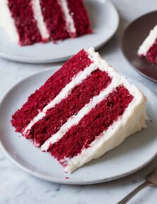 Single slice on a serving plate with two second slices in the background.