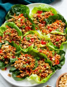 Thai chicken lettuce shown assembled close together on a white oval platter.