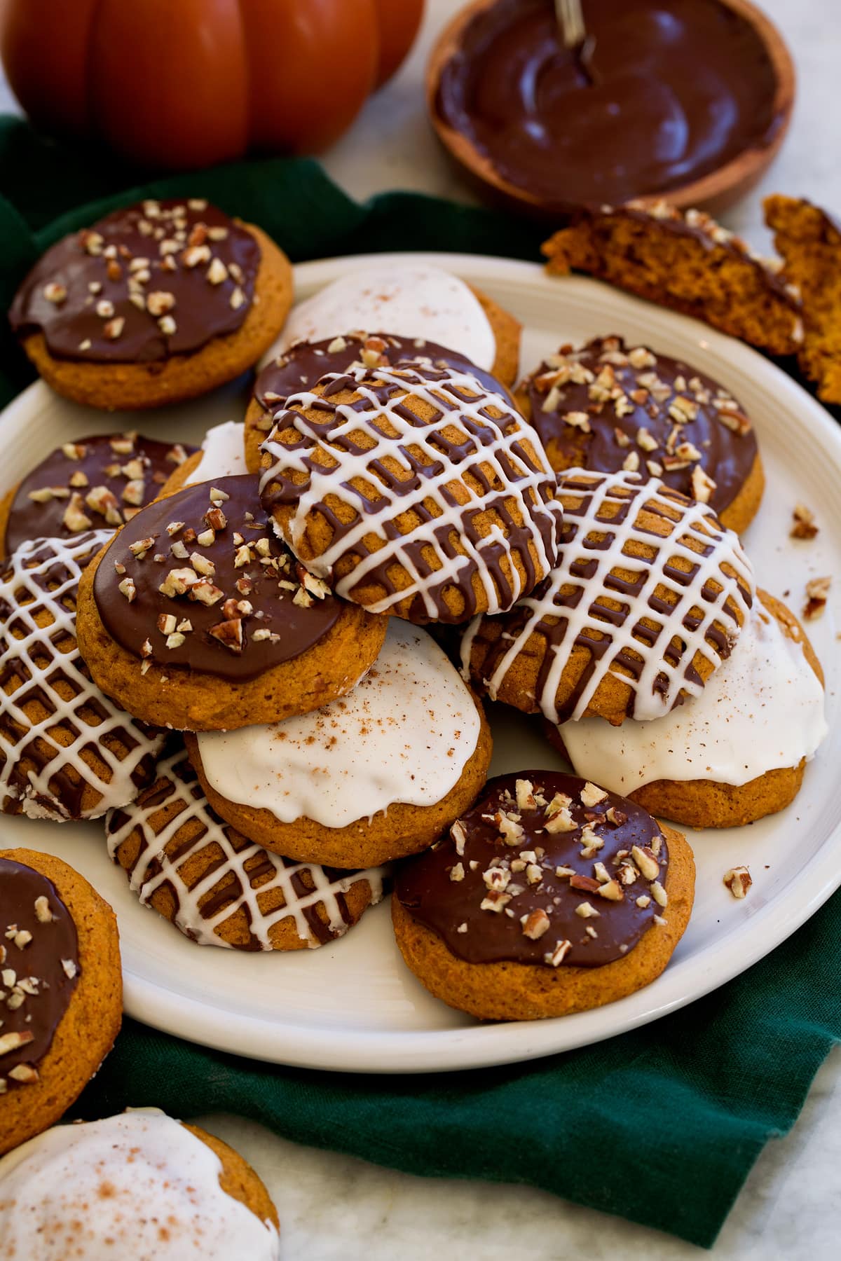 Pumpkin cookies with chocolate and vanilla icing.