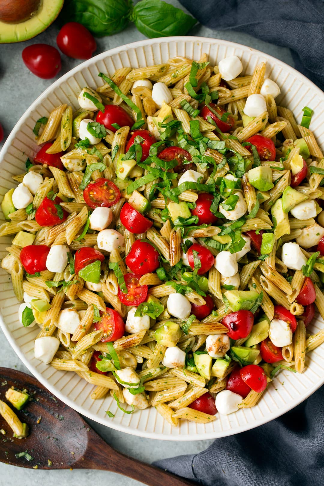 Avocado Caprese Pasta Salad in large white serving bowl