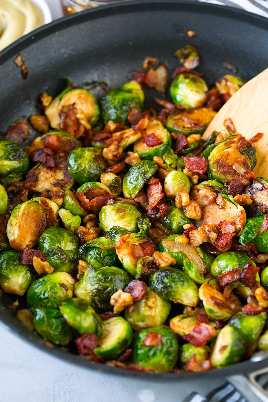 Sauteed Brussels Sprouts with Bacon Onions and Walnuts shown here in a large non-stick skillet