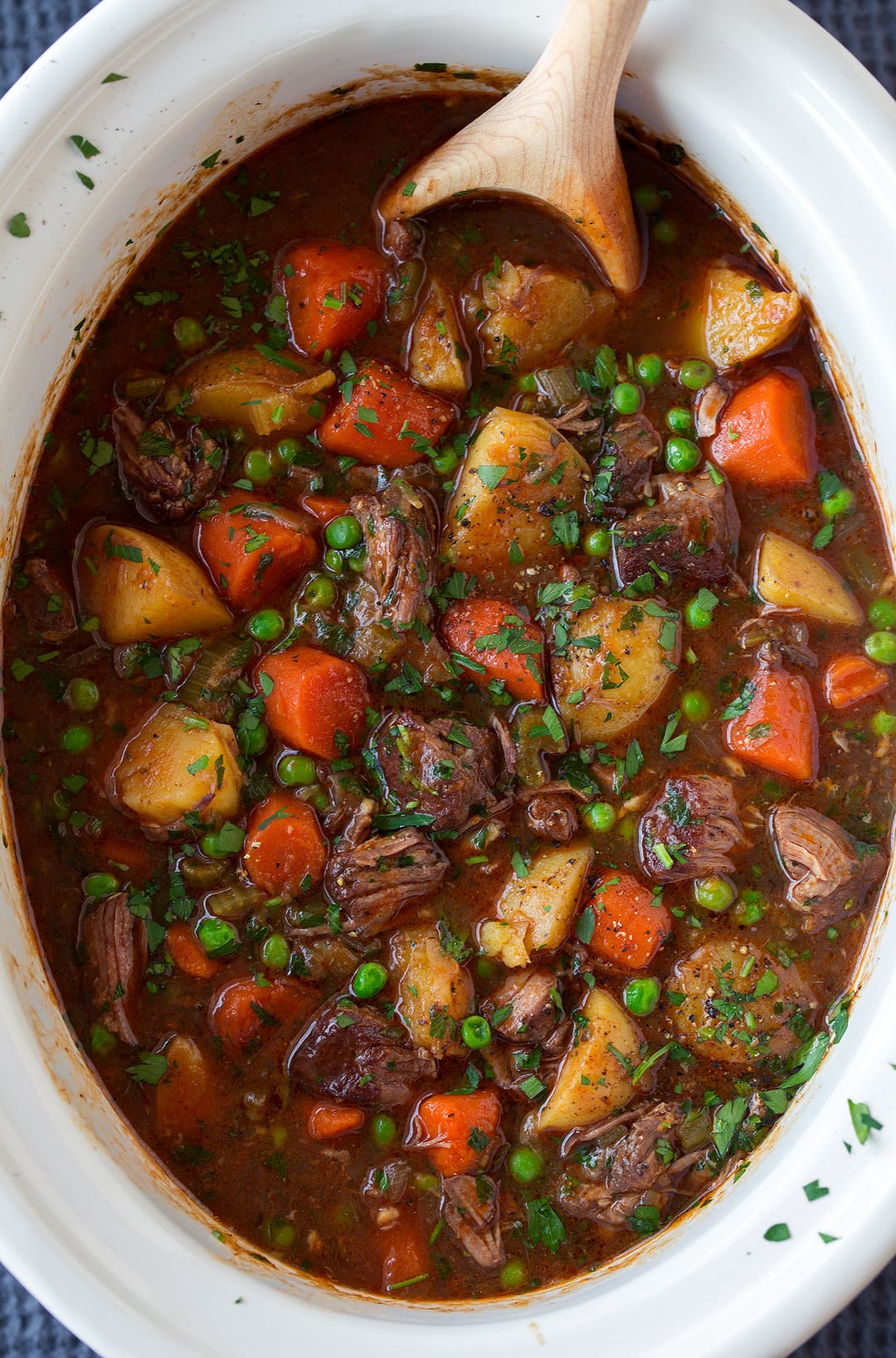 slow cooker Beef Stew with wooden spoon