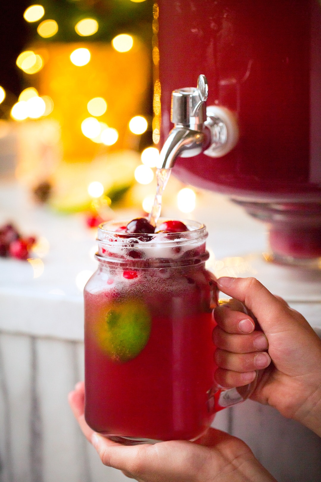 Picture of a dispenser of punch being poured into a single serve cup.