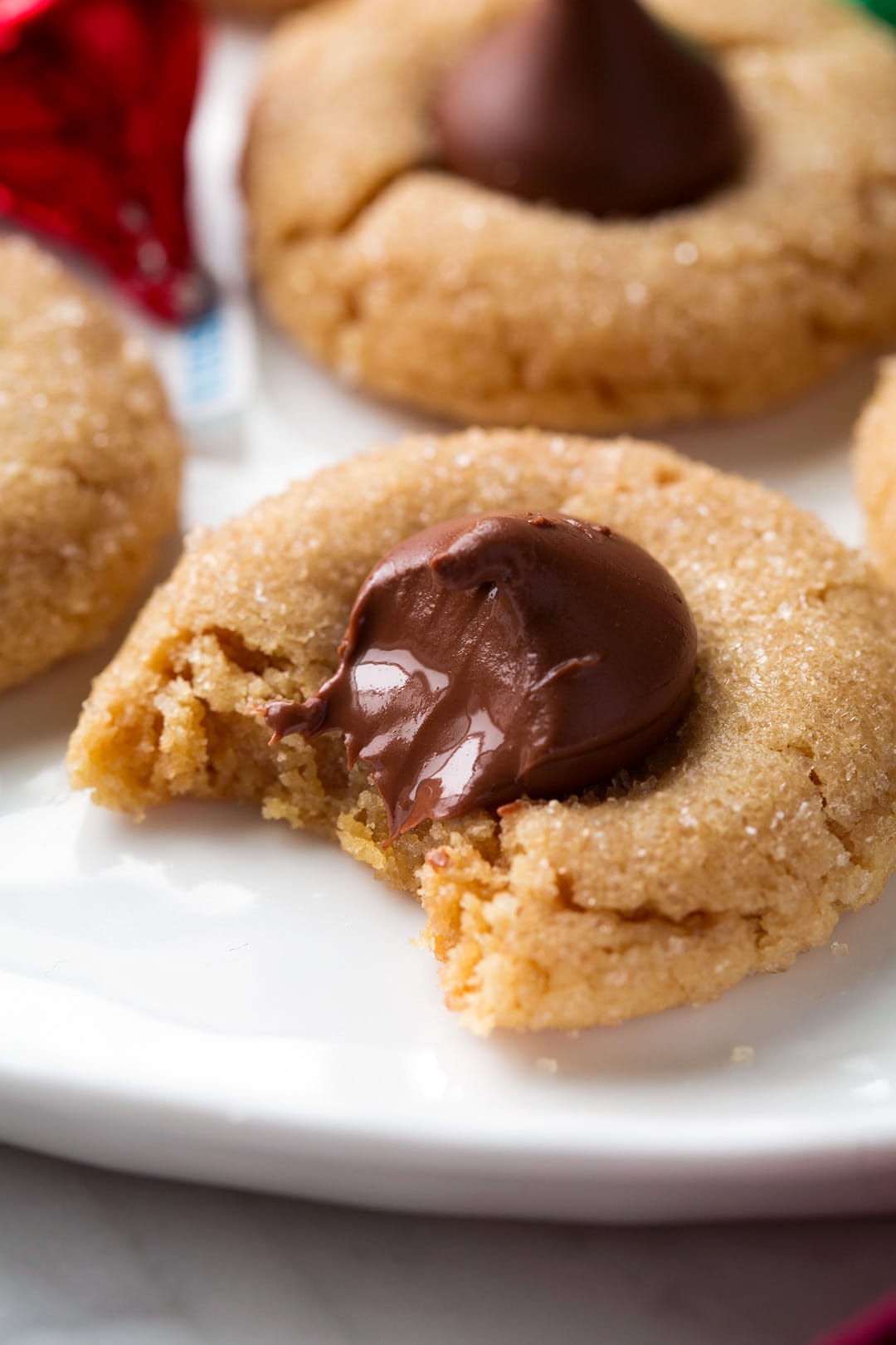 Close up shot of Peanut Butter Blossom Cookie one bite is taken from cookie.