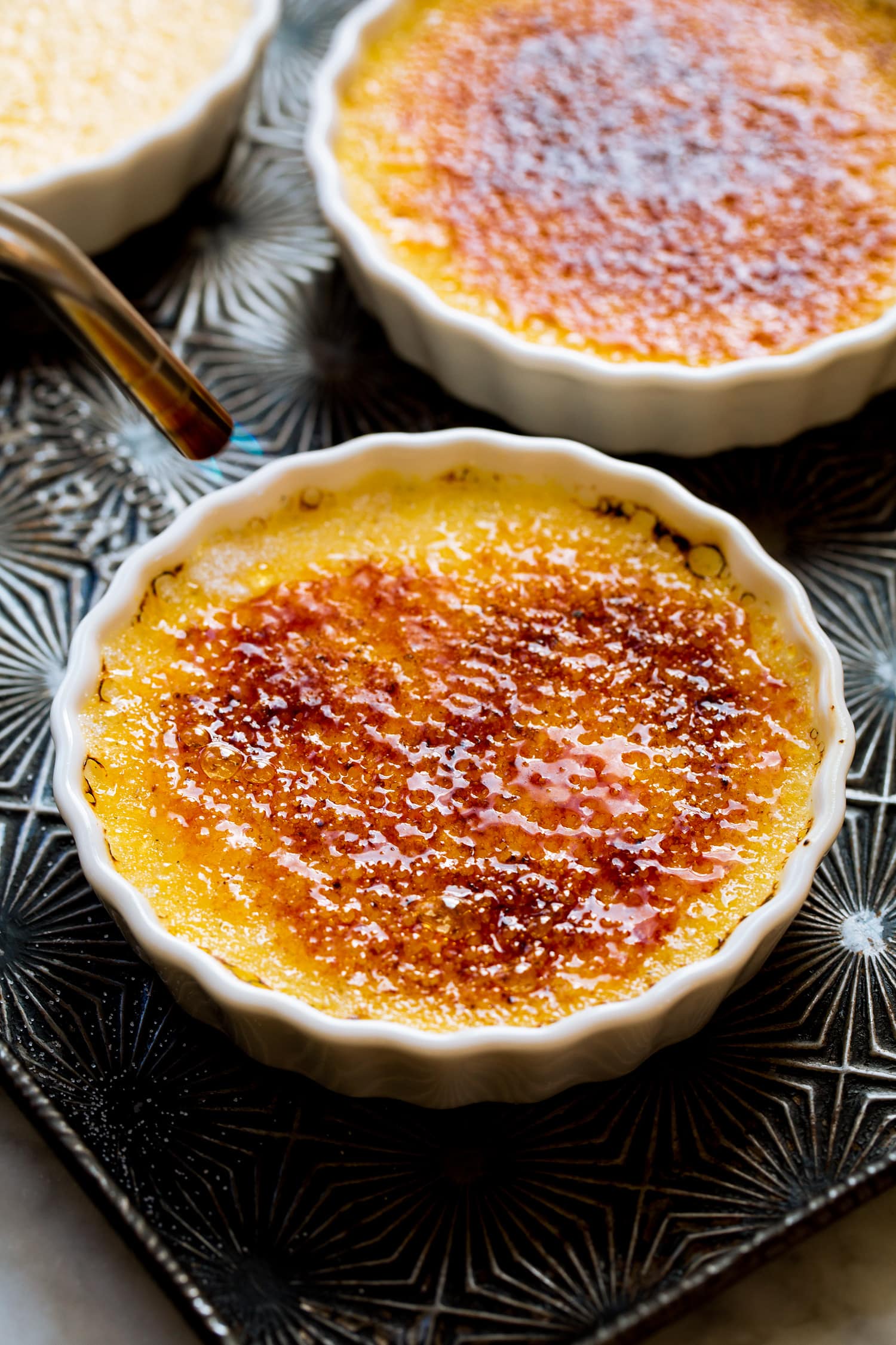 Creme br^ulée sugar being caramelized with a torch.