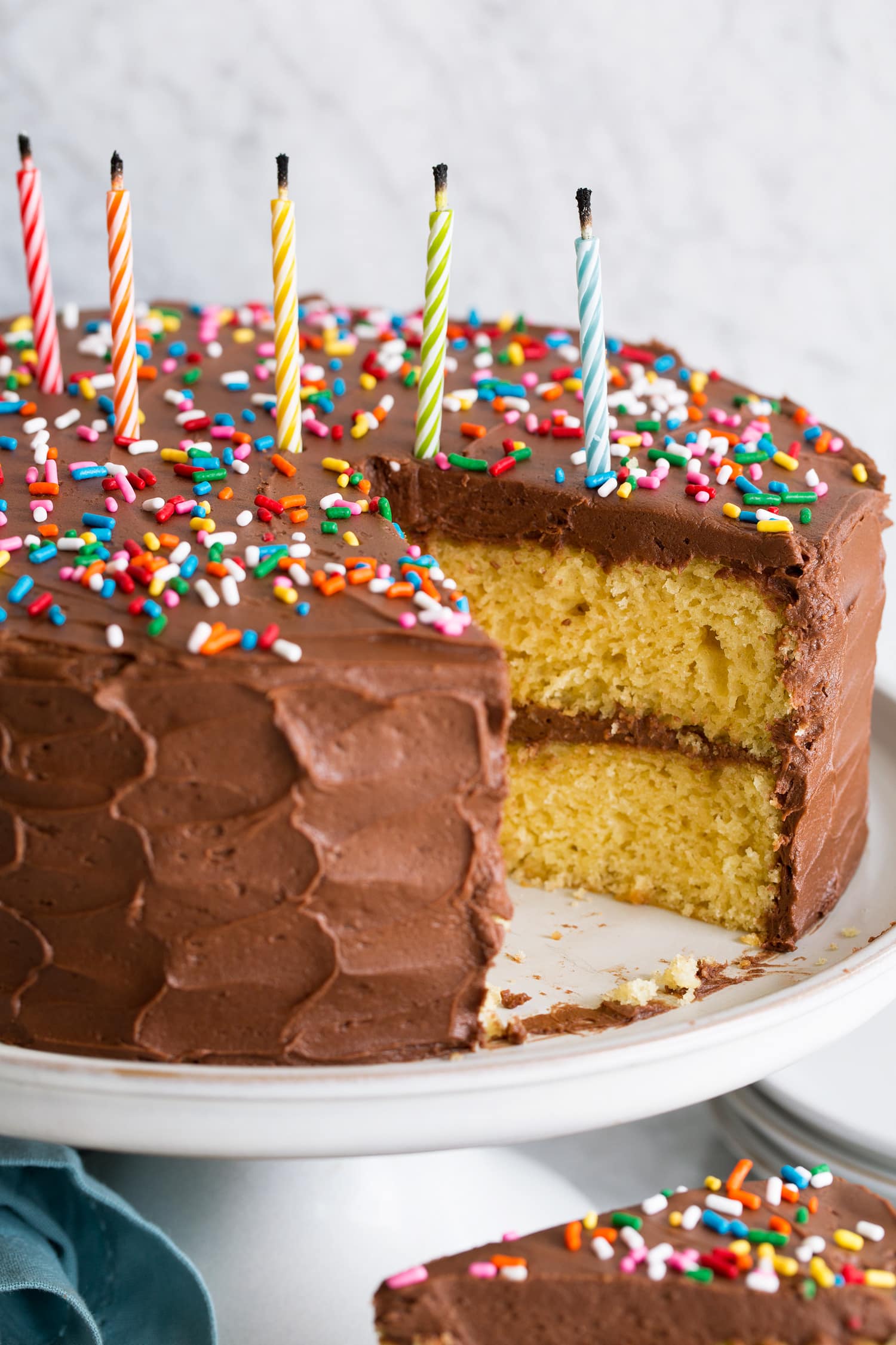 Layered yellow cake on cake stand.