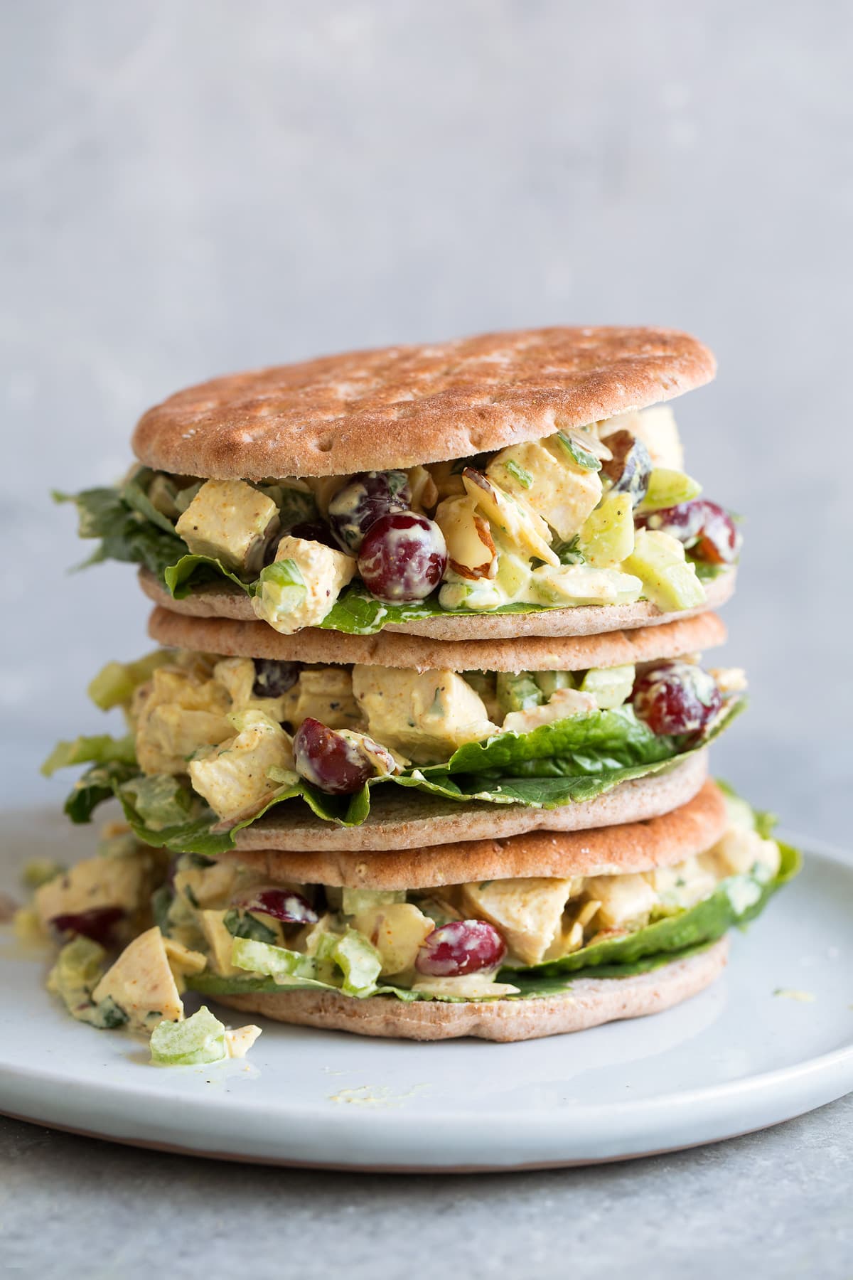 Curry Chicken Salad sandwiches stacked on a white plate