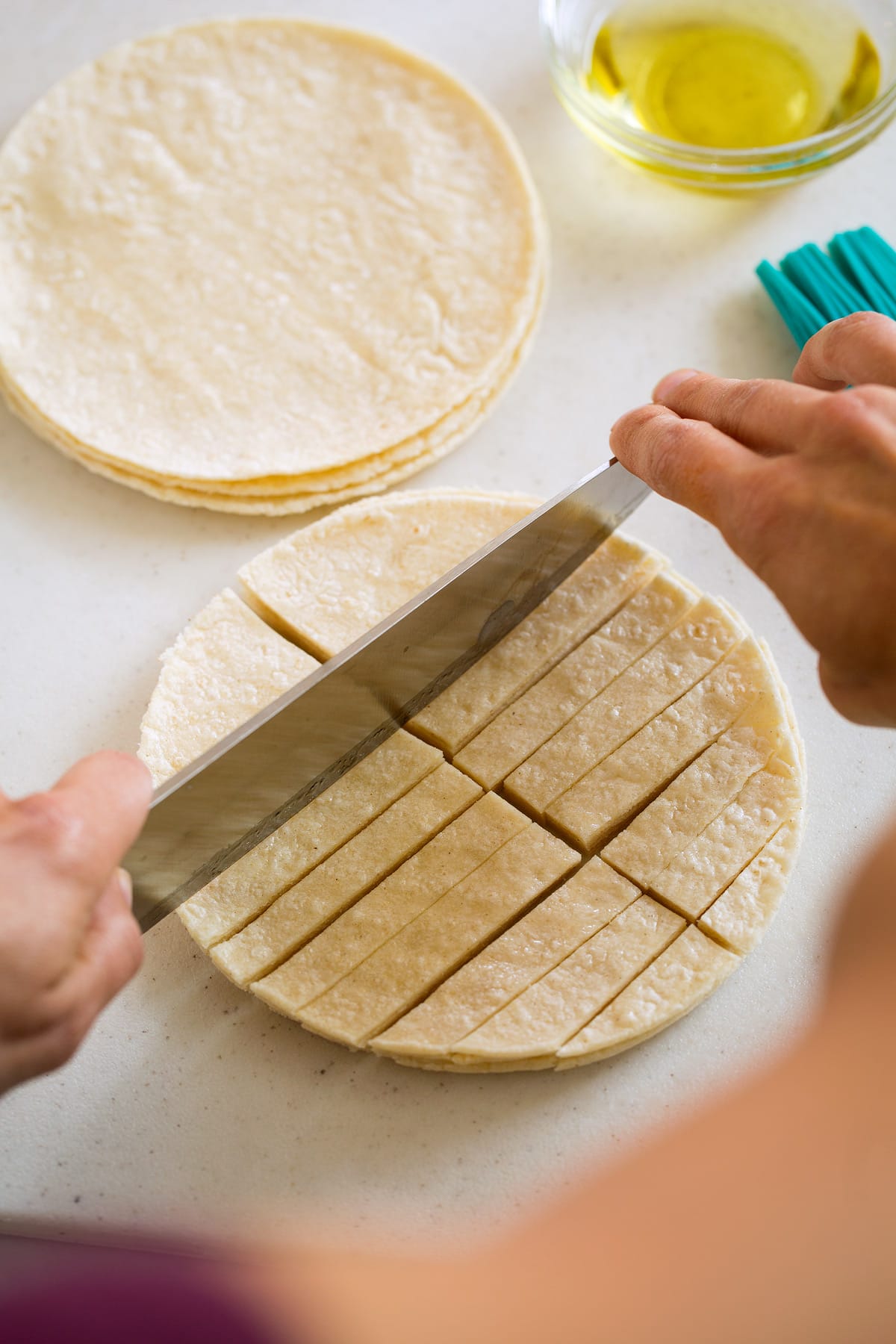 Black Bean Tortilla Soup showing here how to cut tortillas for baked tortilla strips