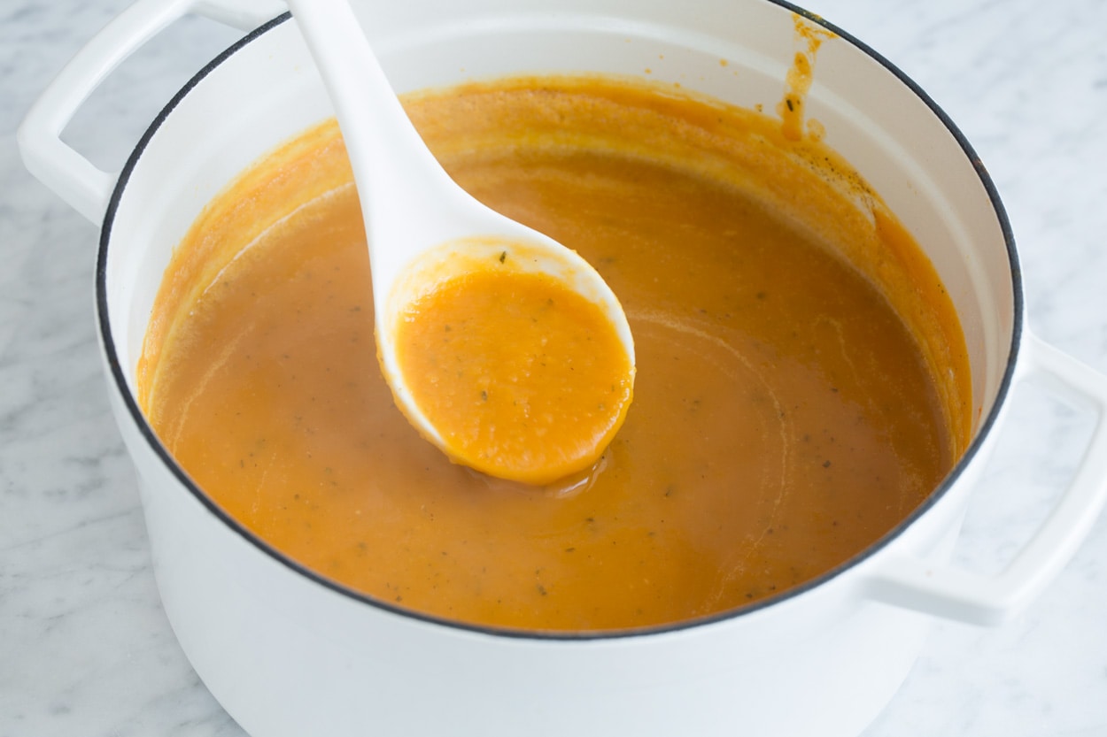 Finished butternut squash soup shown here in enameled white pot