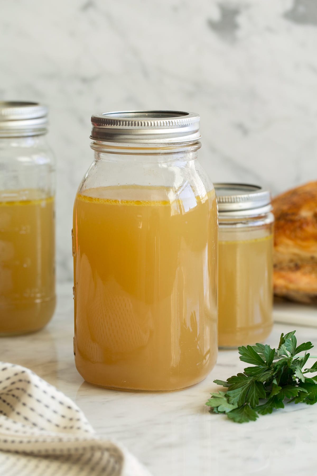 Homemade Chicken Stock in storage jars.