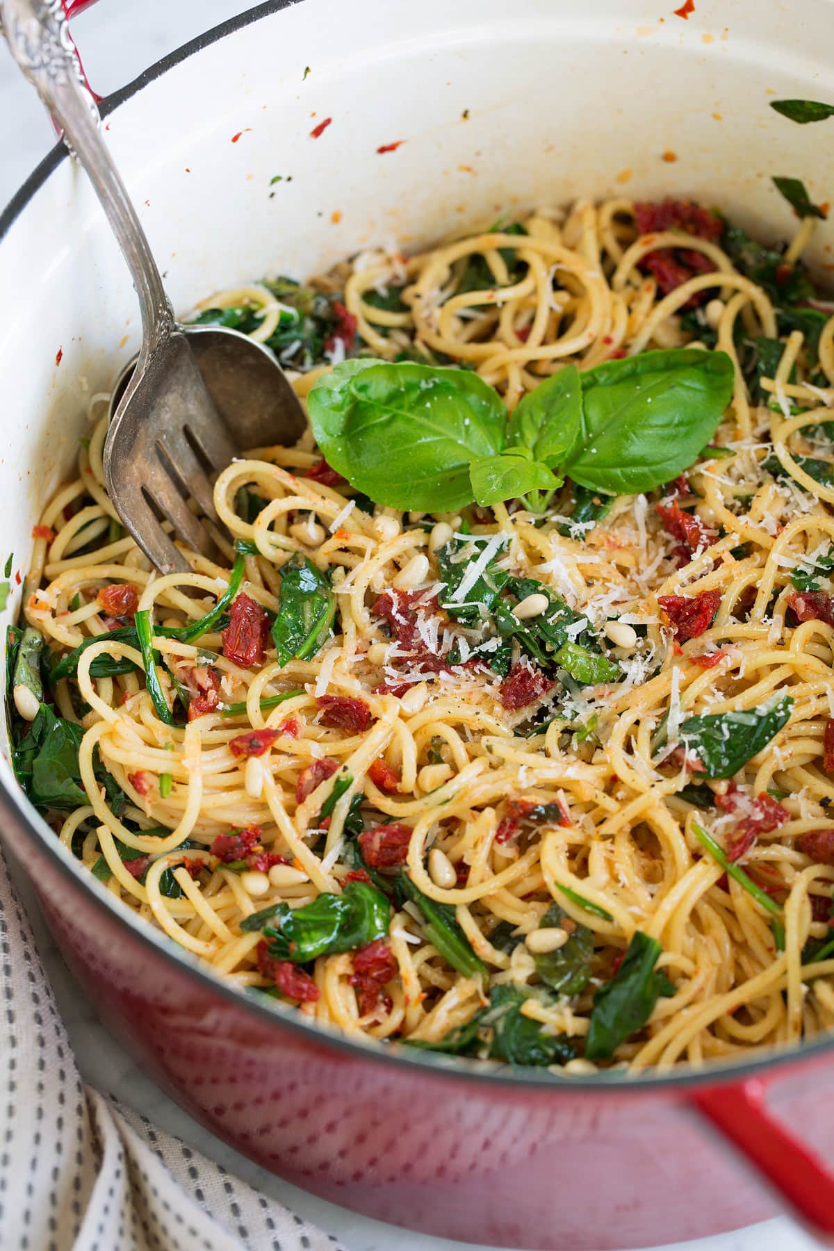 sun dried tomato pasta with spinach in large pot