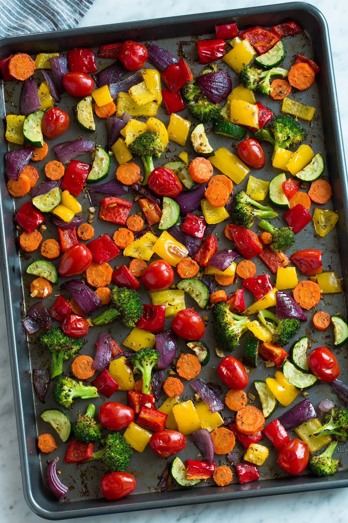 Overheat image of Roasted Vegetables on a dark baking sheet.