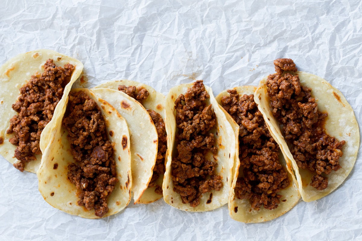 Row of tacos with taco filling.