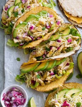 Row of salsa verde chicken tacos.