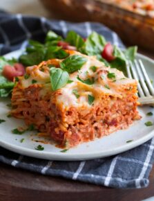 Slice of Baked Spaghetti on a white serving plate.