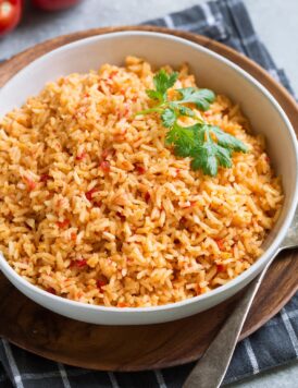 Bowl full of Mexican Rice garnished with cilantro.