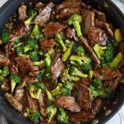 Finished beef and broccoli with sauce in a skillet.