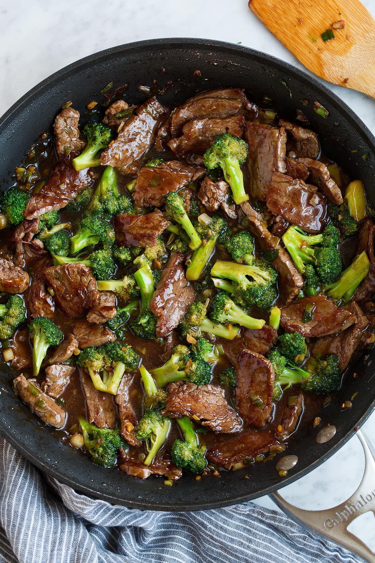 Finished beef and broccoli with sauce in a skillet.