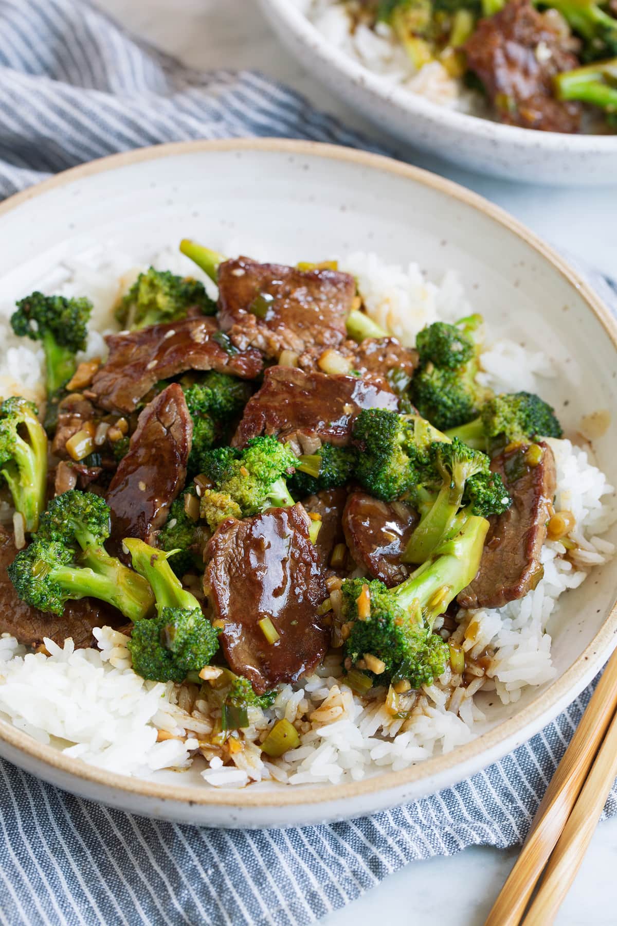 Beef and broccoli over white rice in a bowl.