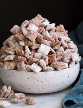 Bowl mounded full of puppy chow muddy buddies.