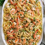 Shrimp scampi on a platter tossed with linguine pasta.