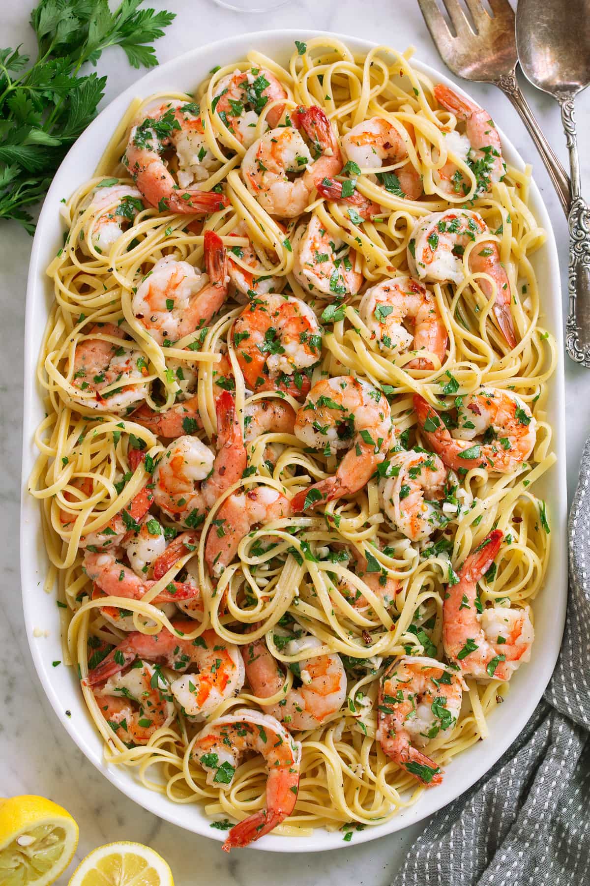 Shrimp scampi on a platter tossed with linguine pasta.