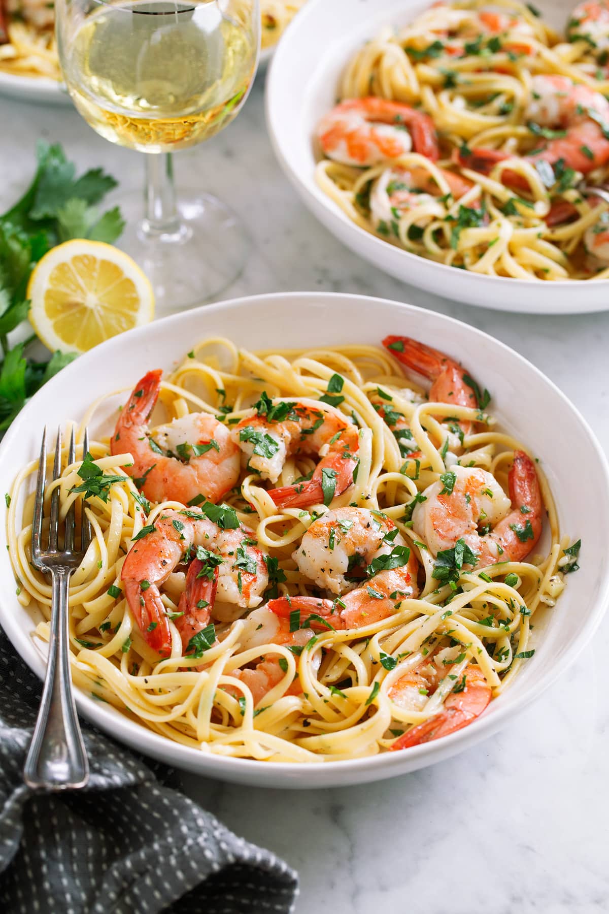 Shrimp scampi servings in pasta bowls.