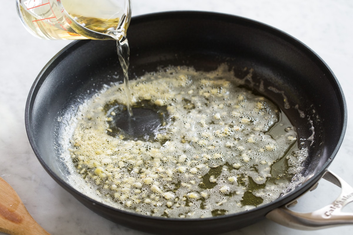 Making shrimp scampi sauce in a skillet.