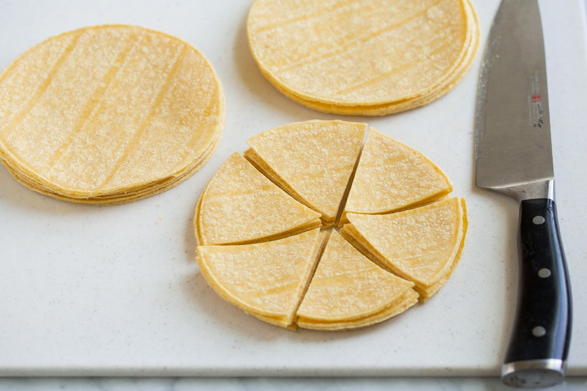 Cutting tortilla stacks into wedges.