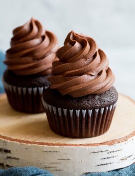 Chocolate buttercream frosting on top of chocolate cupcake