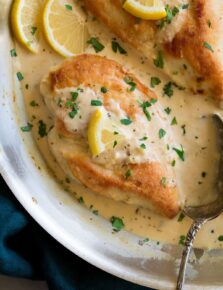 Close up image of chicken breasts in pan in a creamy lemon romano sauce.