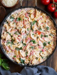 Creamy Spinach Tomato Tortellini shown in a large skillet.