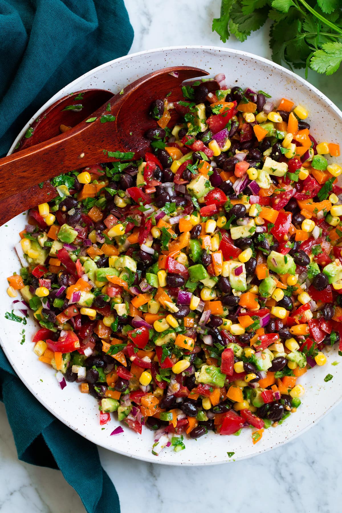 Black bean and corn salad with bell pepper, avocado, tomato and cilantro lime dressing.