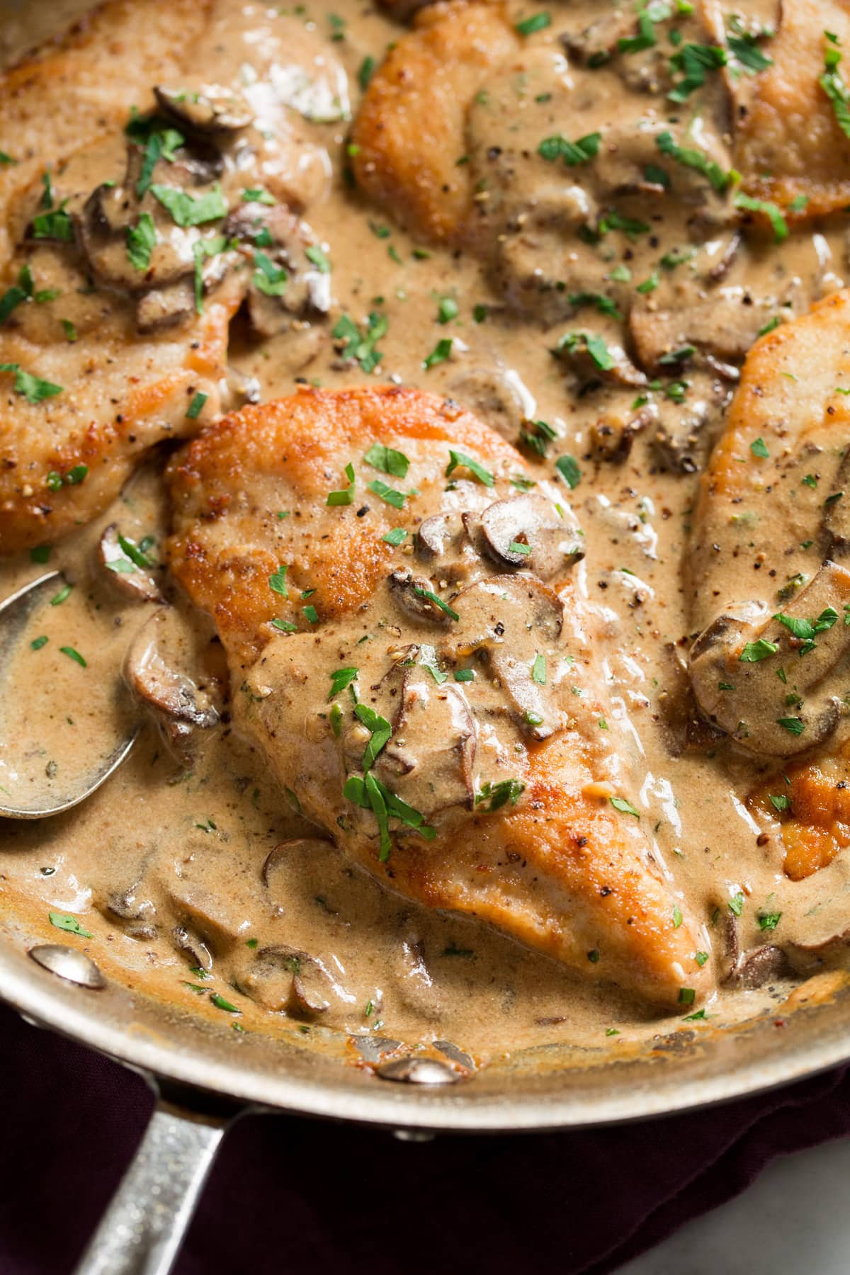 Homemade chicken marsala in a large aluminum skillet.