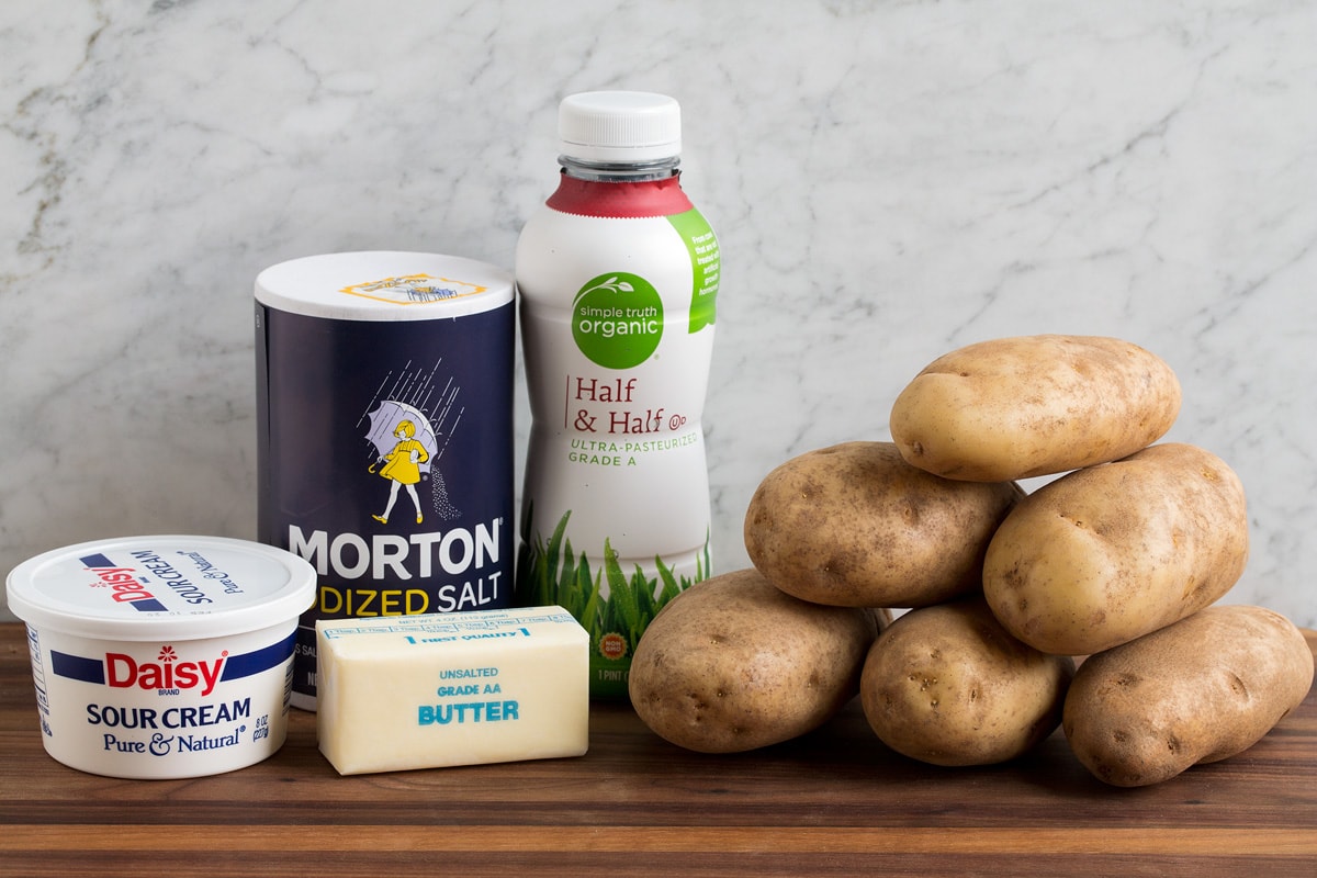 Ingredients used to make mashed potatoes shown here. Includes sour cream, butter, salt, half and half and russet potatoes.