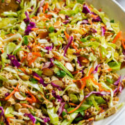 Ramen noodle salad in a serving bowl shown from a side angle.