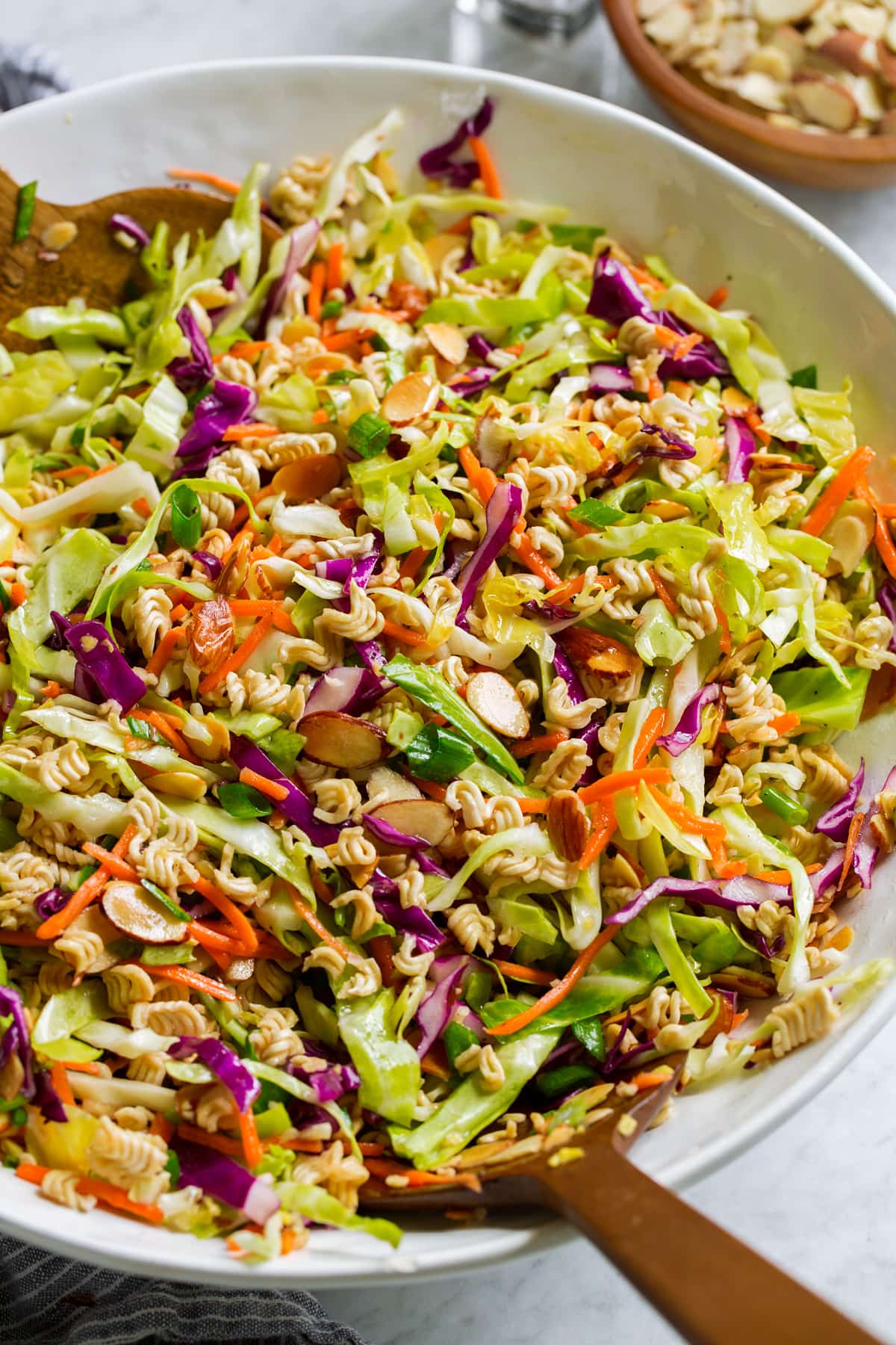 Ramen noodle salad in a serving bowl shown from a side angle.