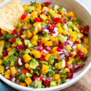 Bowl of mango salsa with a side of tortilla chips.