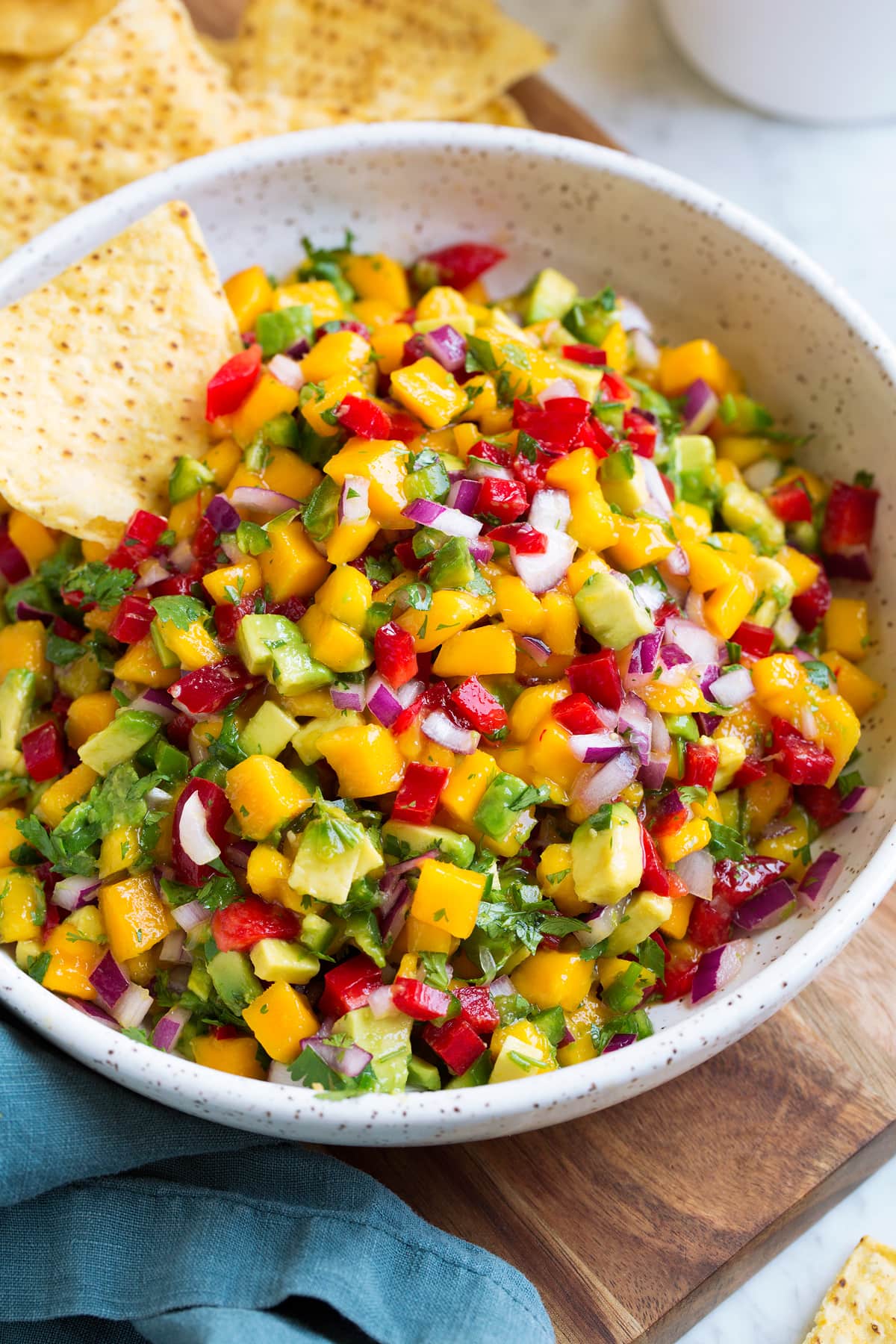 Bowl of mango salsa with a side of tortilla chips.