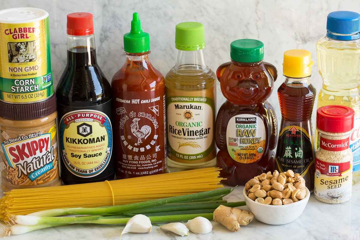 Photo: Ingredients used in making sesame noodles shown here. Includes spaghetti pasta, green onions, garlic, ginger, peanuts, sesame seeds, vegetable oil, sesame oil, honey, rice vinegar, sriracha, soy sauce, peanut butter and cornstarch.