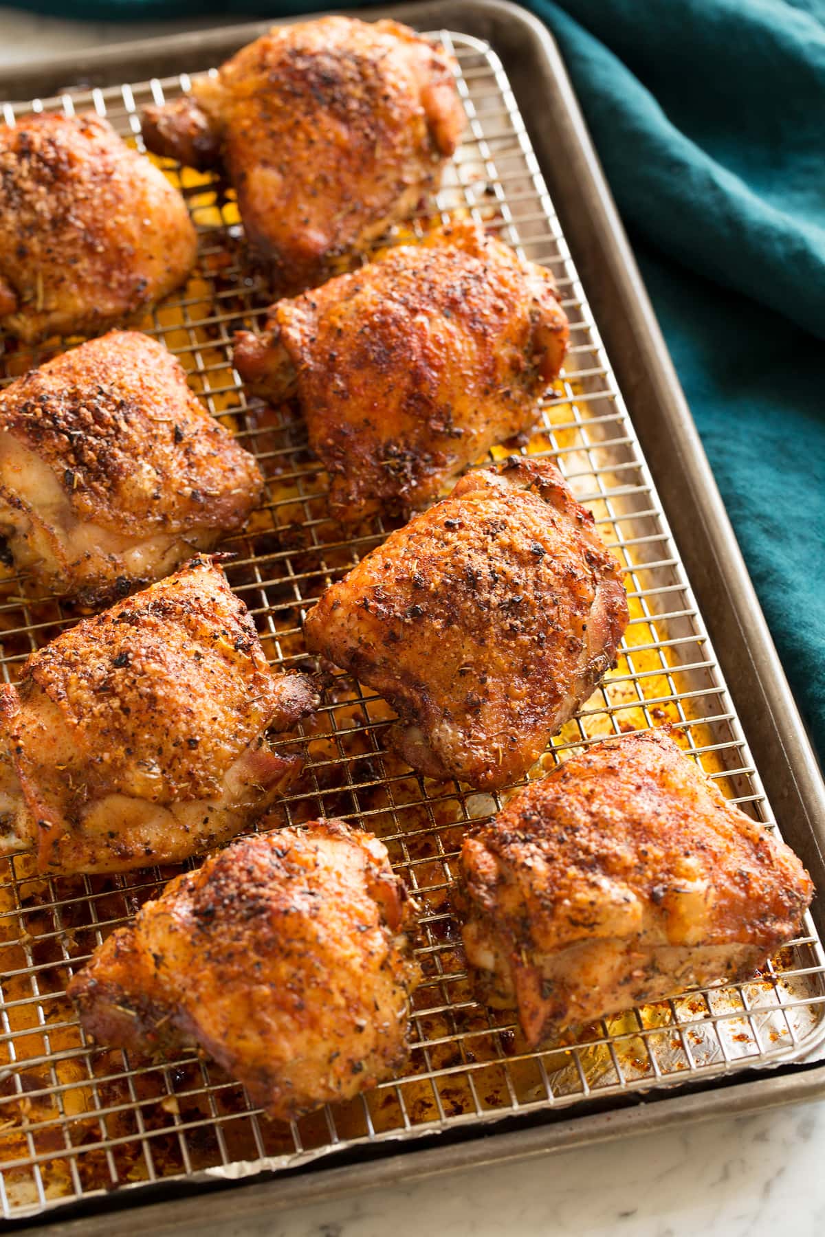 Chicken thighs on wire rack shown after baking.