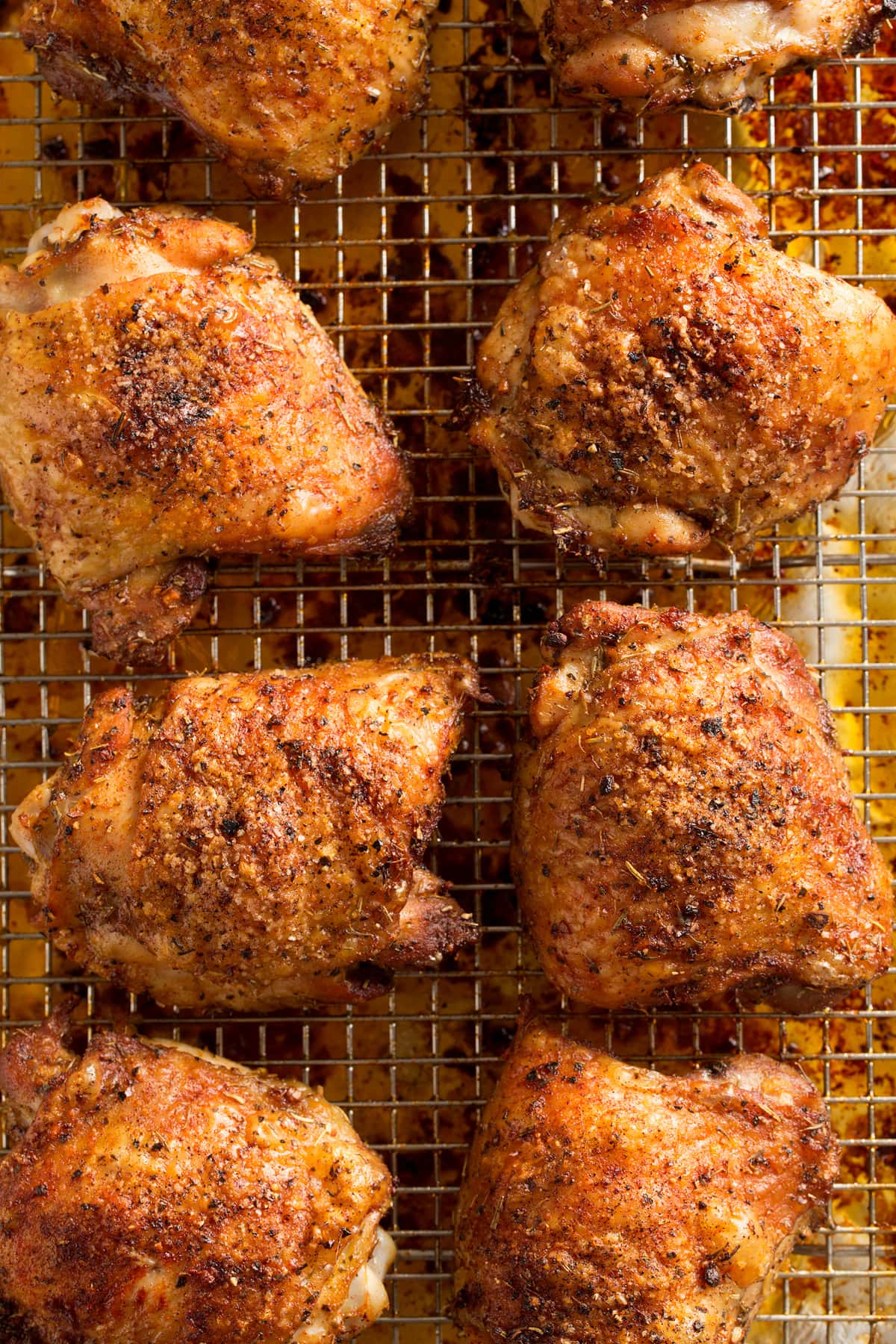 Chicken thighs on wire rack shown close up after baking.