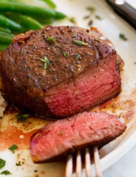 Close up image of filet mignon sliced to show medium rare interior.