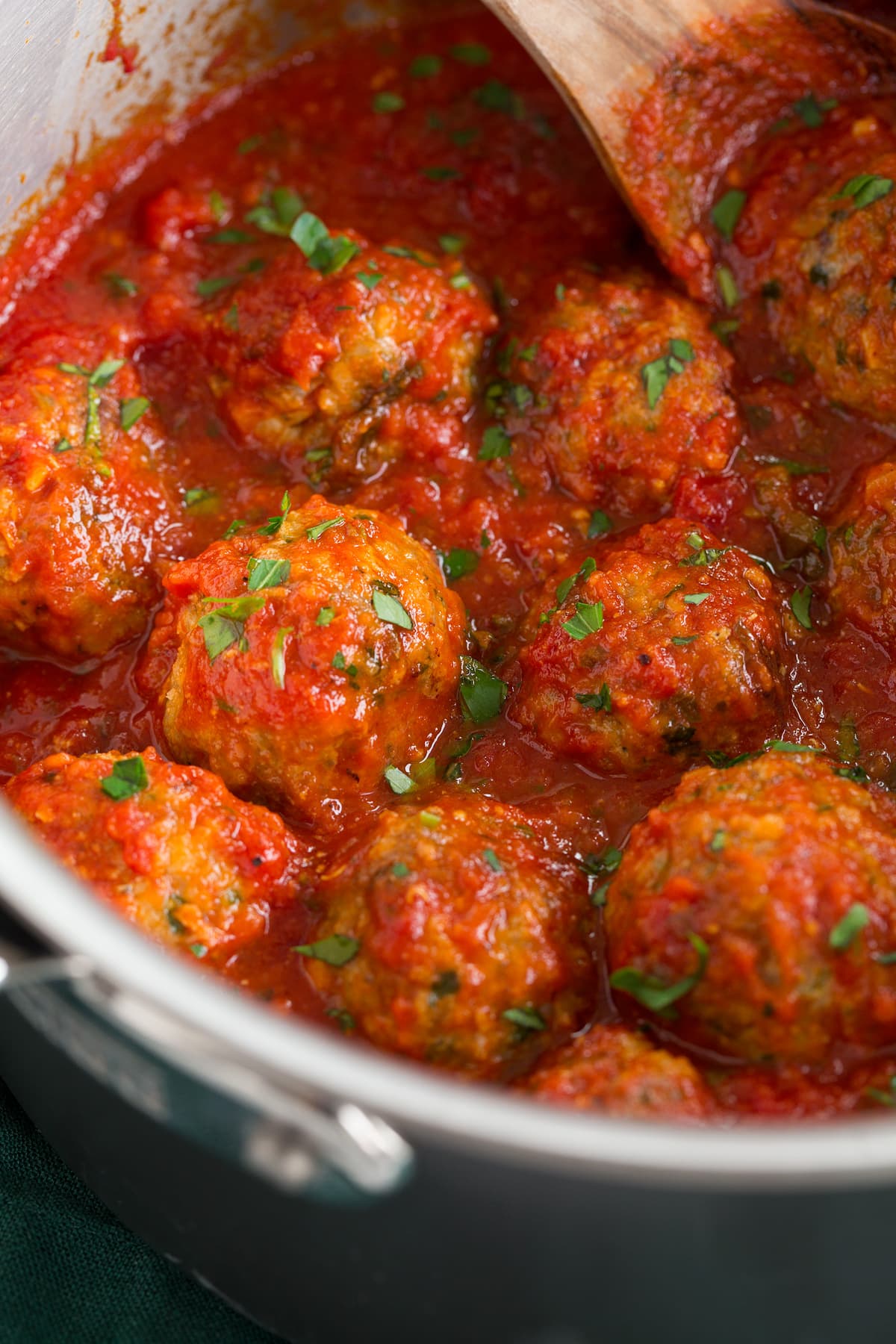 Turkey meatballs in marinara sauce in a saucepan.