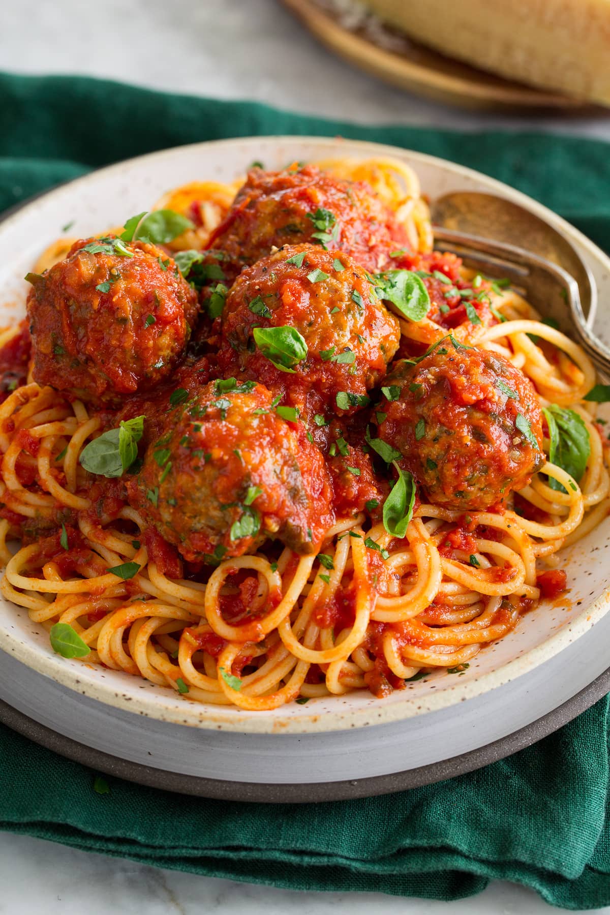 Turkey meatballs and marinara sauce shown over spaghetti pasta.