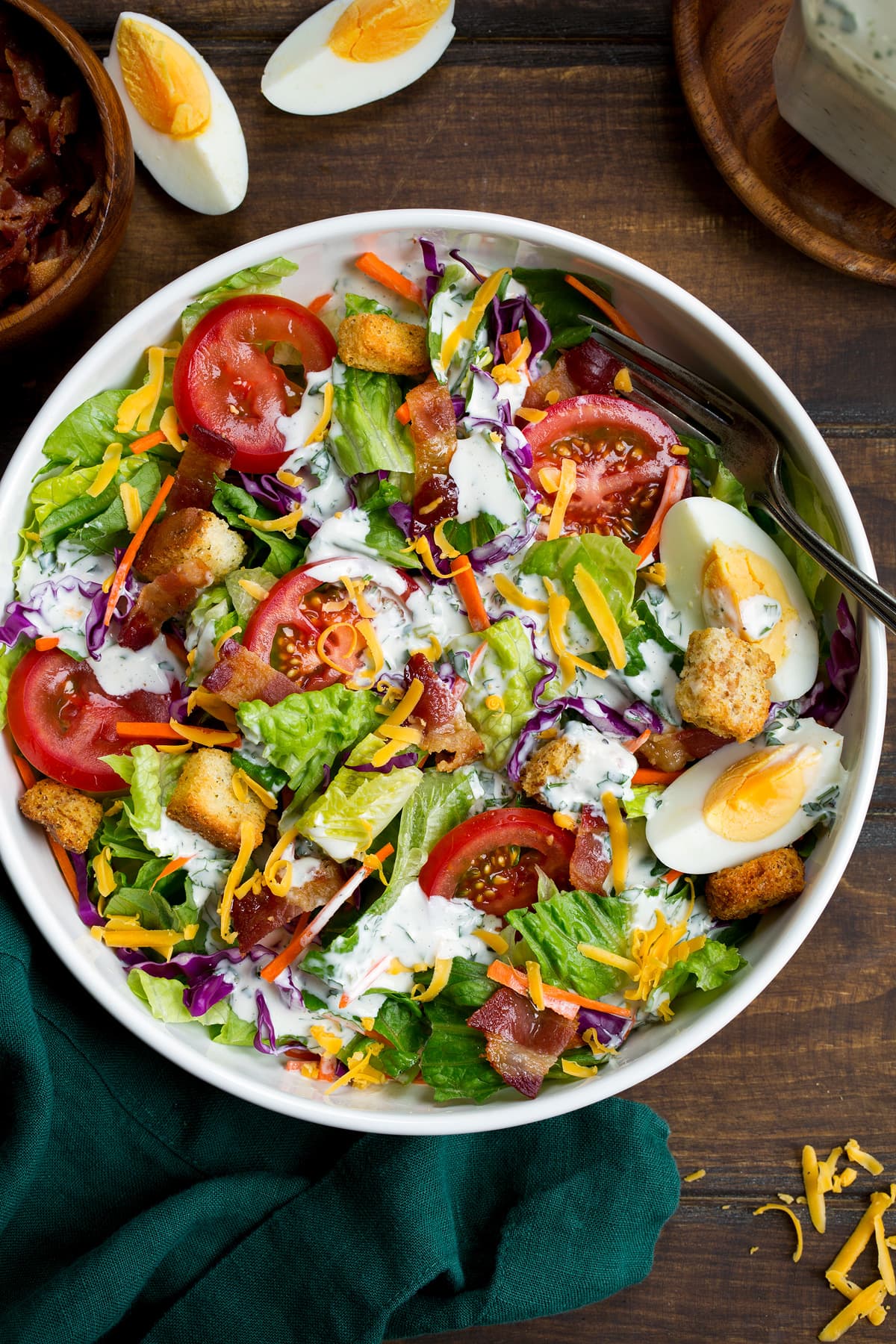 Homemade ranch dressing shown over a green salad.