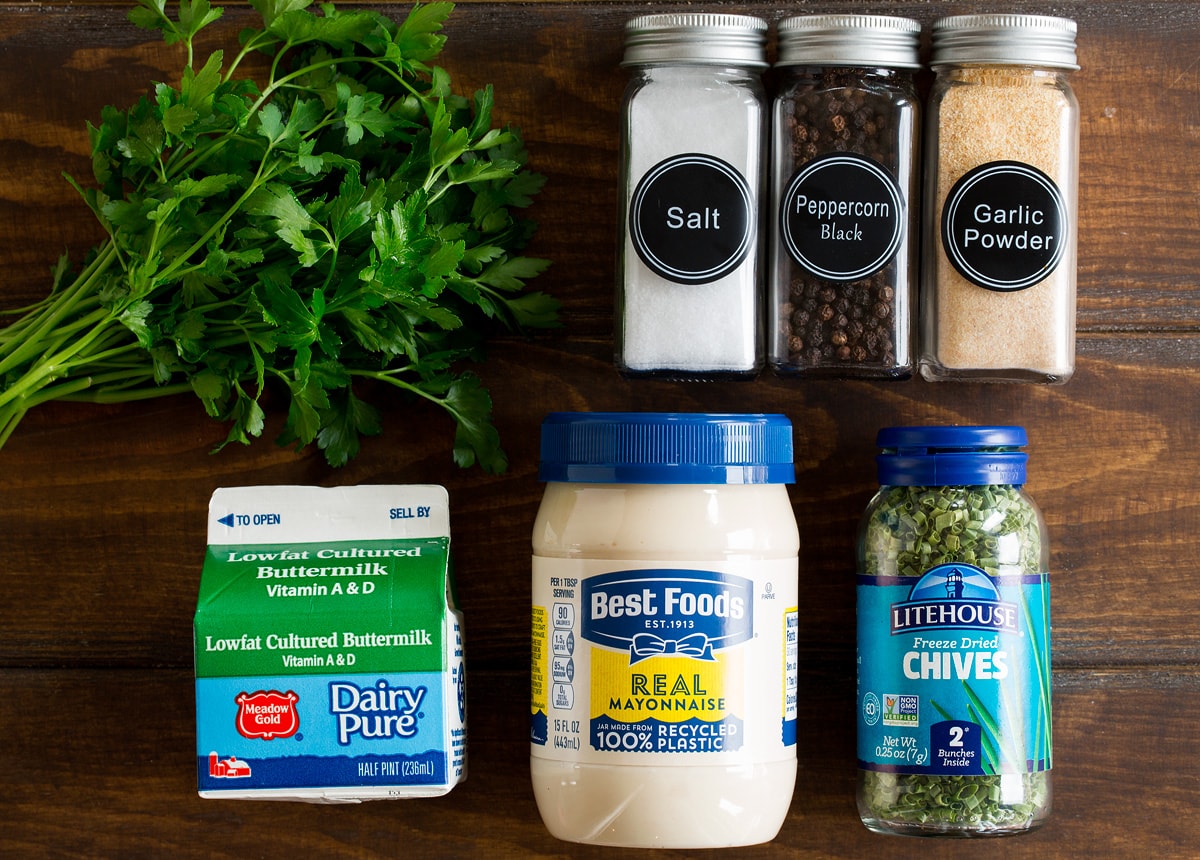 Photo of ingredients used to make ranch dressing. Includes fresh parsley, mayonnaise, buttermilk, dried chives, salt, pepper, and garlic powder.