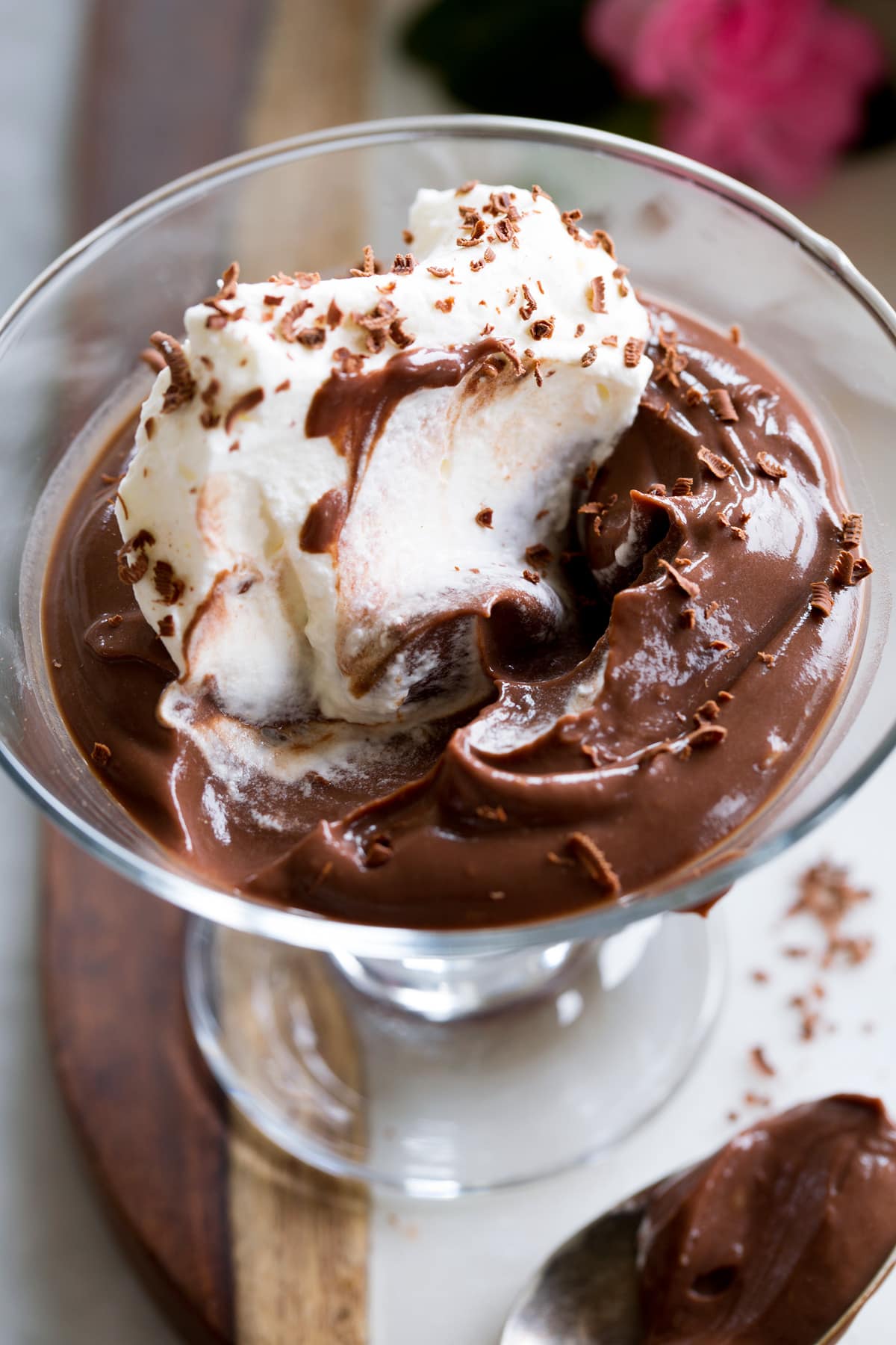 Photo: Close up picture of chocolate pudding and whipped cream with spoonfuls scooped out to show texture.